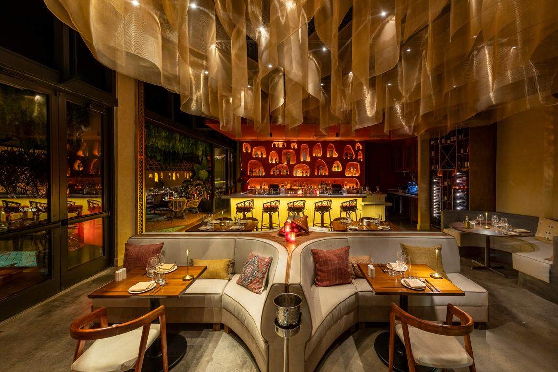 Zuri dining room interior with draped golden ceiling and booth seating by Studio Emanuel